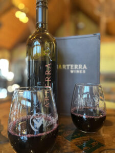 Arterra Wines branded bottle, glasses, and menu book