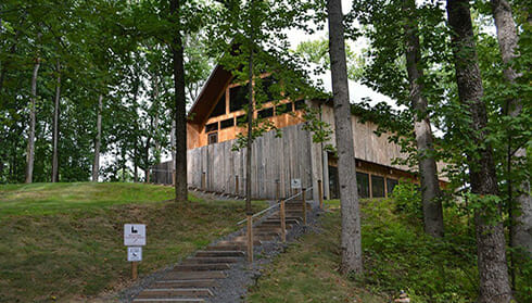Arterra Wines - view of entrance to rustic wooden winery in the woods